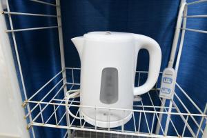 a white appliance sitting in a drying rack at JH Yellow Guest House in Tokyo