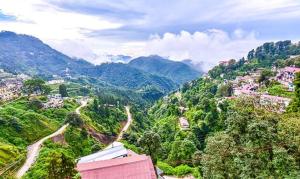 a view of a valley with mountains in the background at FabExpress Clock View in Mussoorie