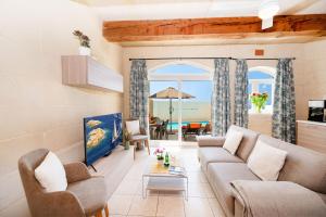 a living room with a couch and a view of the ocean at Veduta Holiday Home in Qala