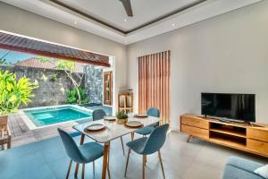 a living room with a table and chairs and a pool at Exclusive 2BR Villa with bathroom en suite and privat Pool in Kerobokan