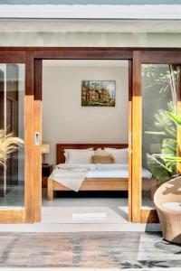 a bedroom with a bed in a room at Exclusive 2BR Villa with bathroom en suite and privat Pool in Kerobokan
