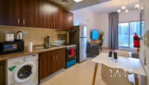 a kitchen with a sink and a dishwasher at Rare Holiday Homes - Close to Stadium - Canal View - Stadium Point - R811 - Dubai Sports City in Dubai