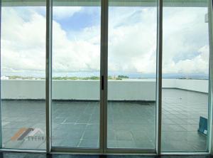a view from the inside of a building through glass doors at Bay Resort Penthouse by Evernent in Miri