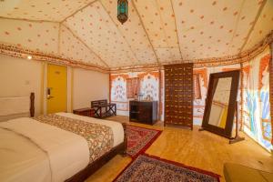 a bedroom with a bed in a room at Hilton Jaisalmer Desert camp in Sām