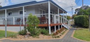 a house with a porch with chairs on it at Serenity Holiday House Port Lincoln Holiday House in Port Lincoln