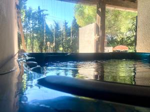 a large pool of water in a house at Villa 110m2, 7 pers, Jacuzzi , 3 chambres, terrain clos et arboré 2500m2 in Trèbes