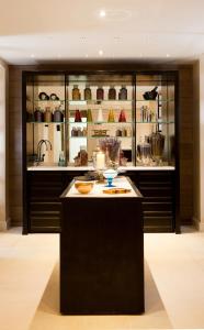 a kitchen with a black island in a room at The Gainsborough Bath Spa - Small Luxury Hotels of the World in Bath