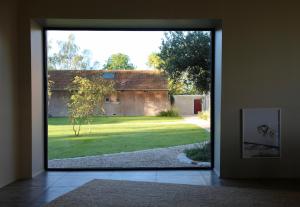 an open door with a view of a yard at CASAMAAS in Les Basses Masures