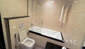 a small bathroom with a toilet and a shower at Spacious Studio APT - Near Expo 2020 - Dubai South R410 in Dubai