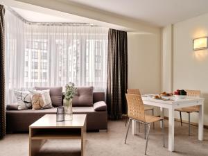 a living room with a couch and a table at Apartamenty Media Park in Warsaw