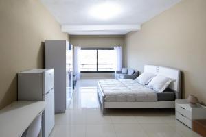 a small bedroom with a bed and a window at Milestone City - Appartements à louer in Antananarivo