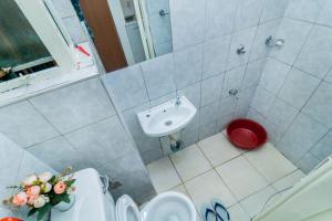 a small bathroom with a sink and a toilet at Gracie's Cosy Residence in Kiambu