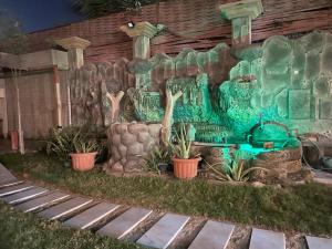 a garden with a water fountain in a yard at شاليه سهم in Al Khobar