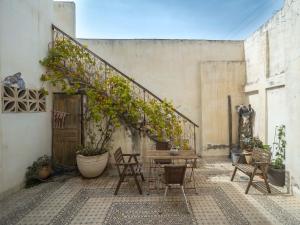 un patio con una mesa y sillas y una escalera en Studio Trendy Kerem center tel aviv, en Tel Aviv