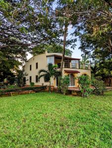 a house with a lawn in front of it at Le Pleiadi in Malindi