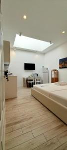 a bedroom with a bed and a flat screen tv at BARBARA Classy Apartment 101 in Siracusa