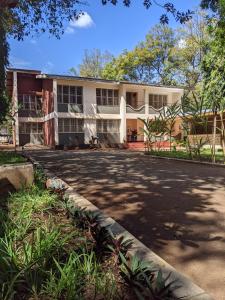 a building with a driveway in front of it at Karibu Homestay Moshi in Moshi