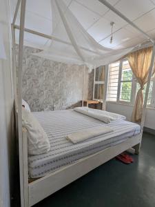 a bed with a canopy in a bedroom at Karibu Homestay Moshi in Moshi