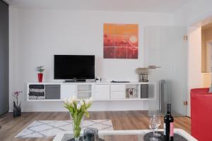 a living room with a television on a white entertainment center at Ferienwohnung Bergischer Panoramasteig in Radevormwald