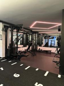 a gym with treadmills and machines in a room at Hotel Stockalperhof in Brig