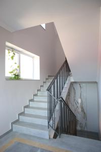 a staircase in a house with white walls and a window at RIVER SIDE in Polyana