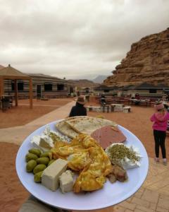 a plate of food on a table in a desert at Wadirum winter in Wadi Rum