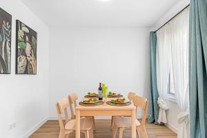 a dining room table with chairs and food on it at Holiday Garden House in Golf del Sur in San Miguel de Abona