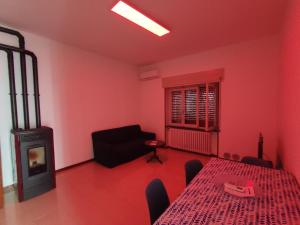 a living room with a table and a fireplace at Casa Zoe in Piacenza
