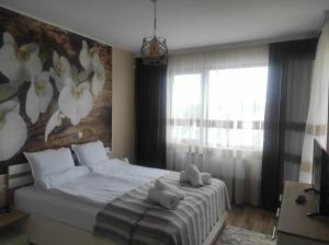 a bedroom with a large bed with a flower mural at Апартамент Четири сезона 2 in Velingrad