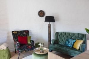 a living room with a couch and a chair at Renovated Mill in Sint-Niklaas