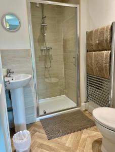 a bathroom with a shower and a toilet and a sink at The Graph’s Gaff 