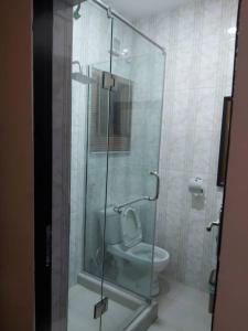 a bathroom with a glass shower with a toilet at Pious Court in Port Harcourt
