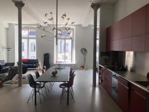 a kitchen and dining room with a table and chairs at Design Loft in ehemaliger Spinnerei in Mels