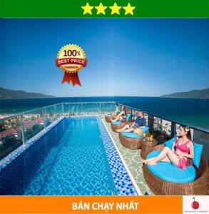 a group of people sitting in chairs by a swimming pool at Anh Đào Hotel & Apartment in Da Nang