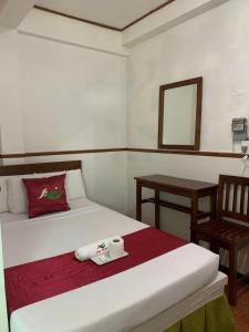 ein Zimmer mit einem Bett und einem Stuhl mit einem Tablett darauf in der Unterkunft Axis Pension Hotel in Mactan