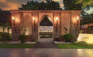 a kiosk in a garden at night at Courtyard by Marriott Agra in Agra