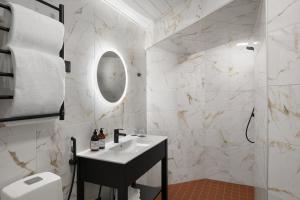 a bathroom with a sink and a mirror at Hotel Kakola in Turku