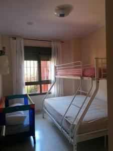 une chambre avec deux lits superposés et une fenêtre dans l'établissement Apartamento Los Moriscos Golf Playa Granada, à Motril 13 autres photos