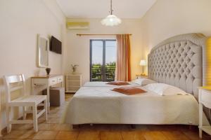 a bedroom with a large bed and a window at Eleni's Garden 3 in Alikanas