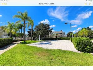 a park with palm trees and a street light at Mickey Holiday Home a Windsor Palms Villa in Kissimmee