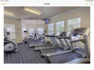 a gym with treadmills and ellipticals in a room at Mickey Holiday Home a Windsor Palms Villa in Kissimmee
