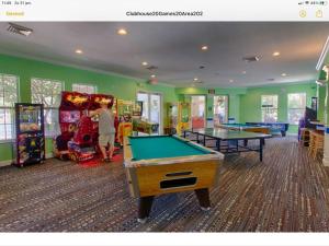 a room with billiard tables and arcade games at Mickey Holiday Home a Windsor Palms Villa in Kissimmee