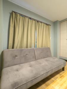 a large couch in a room with a window at 殿堂 in Tokyo