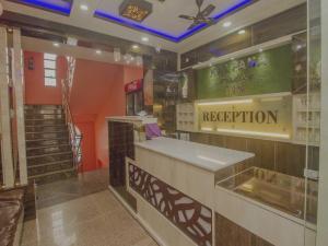 a restaurant with a reception counter in a room at Kalpana Residency Inn in Siliguri