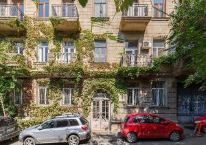 two cars parked in front of a building at HD Dream Apartment in Tbilisi City