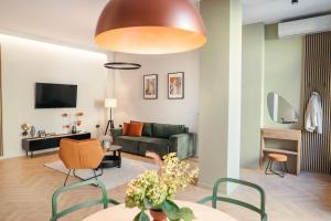 a living room with a couch and a table at The Middle House in Satu Mare