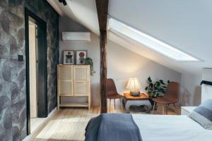 a bedroom with a bed and a table and chairs at The Middle House in Satu Mare