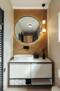 a bathroom with a sink and a mirror at The Middle House in Satu Mare