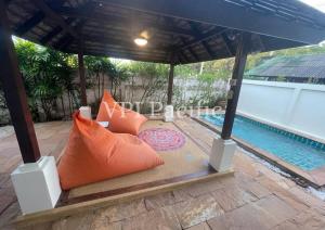 a bed in a gazebo next to a swimming pool at Jacuzzi Pool Villa Isabelle 1bed in Nathon Bay