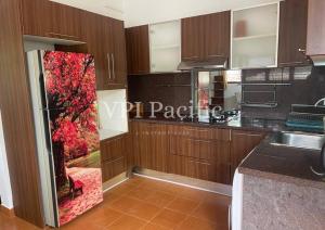 a kitchen with wooden cabinets and a red chair in it at Jacuzzi Pool Villa Isabelle 1bed in Nathon Bay